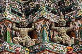 Bangkok Wat Arun - Statues of the mythical  demon bears  that support the different levels of the Phra prang.